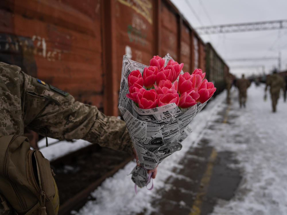 Soldiers arrive at the Kramatorsk train station, in eastern Ukraine, holding flowers for their wives and girlfriends.