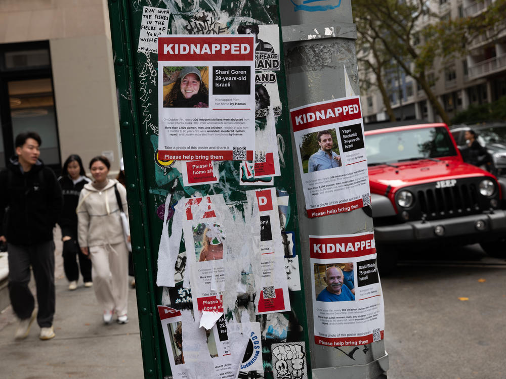 Posters of some of those kidnapped by Hamas in Israel are displayed on a pole in Manhattan.