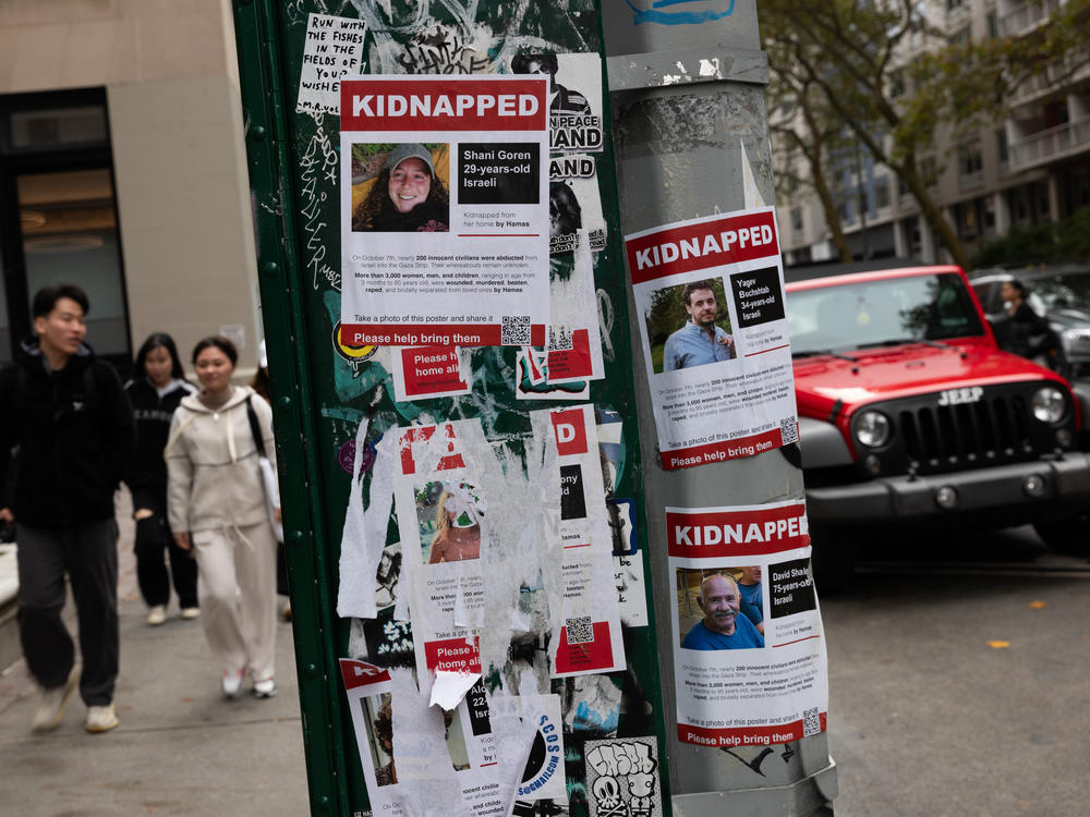 Posters of some of those kidnapped by Hamas in Israel are displayed on a pole in Manhattan.