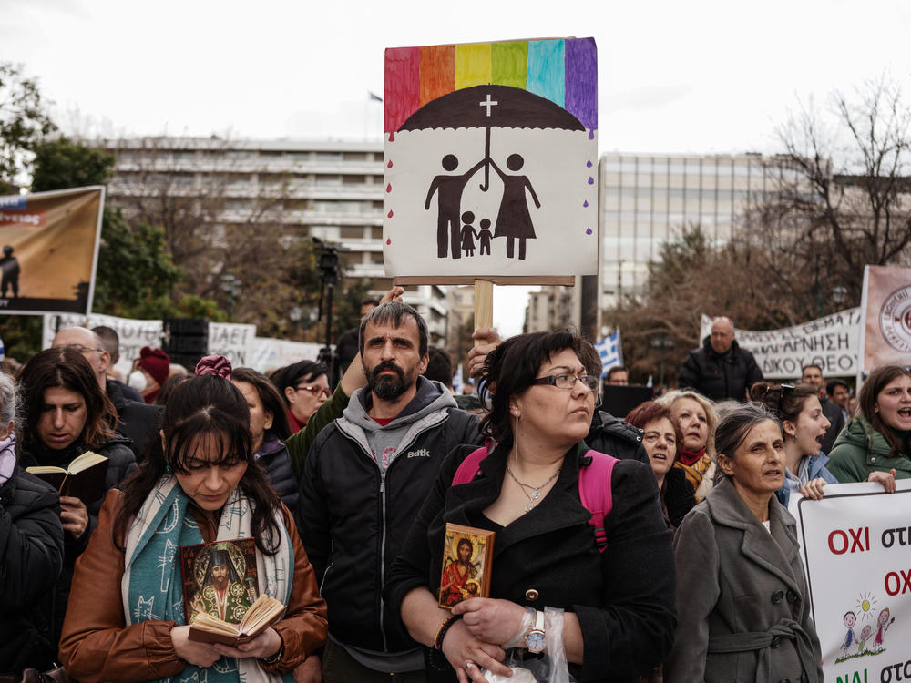 Protesters hold banners during a demonstration against the upcoming vote in parliament on the same-sex marriage bill, in Athens on Feb. 11. Greece's parliament is set to vote on legislation to legalize same-sex marriage on Thursday.