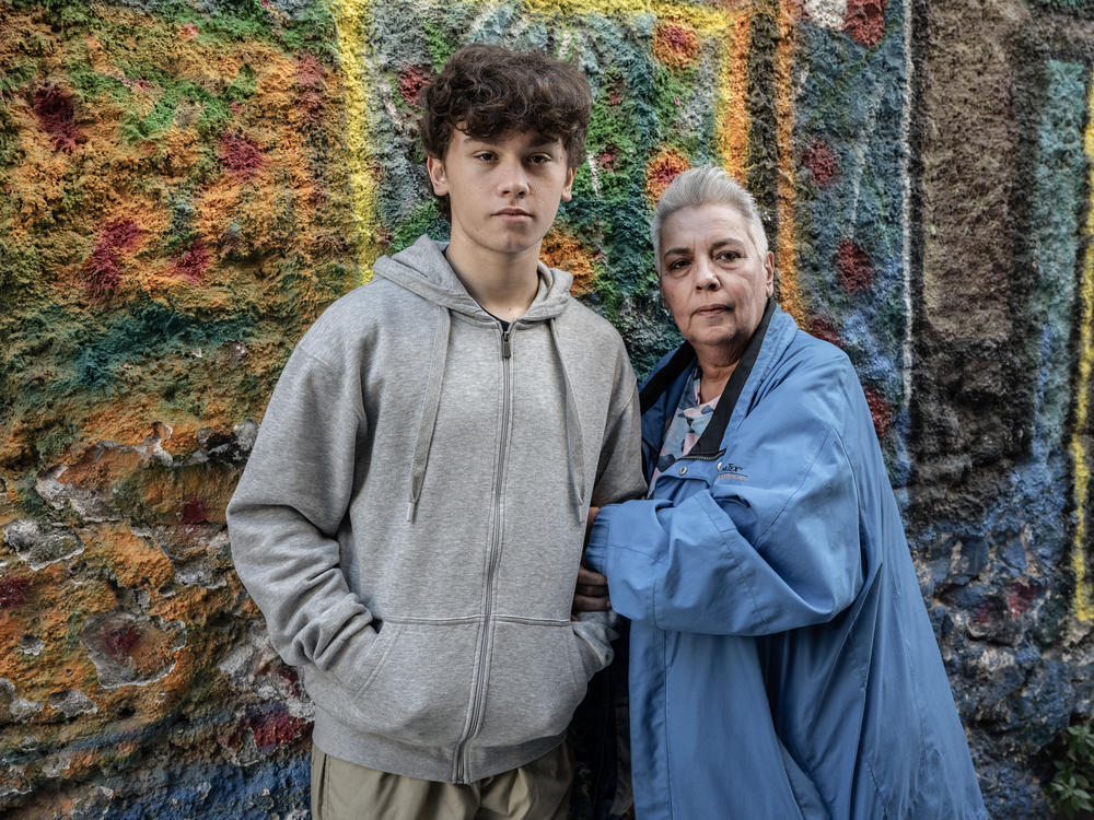 Stella Belia (right), a member of the Rainbow Families of Greece, an organization that focuses on LGBTQ parents, poses for a portrait with one of five children, Yannis, in Athens, on Jan. 30. Greek lawmakers are set to vote on a bill legalizing same-sex marriage and adoption this week.