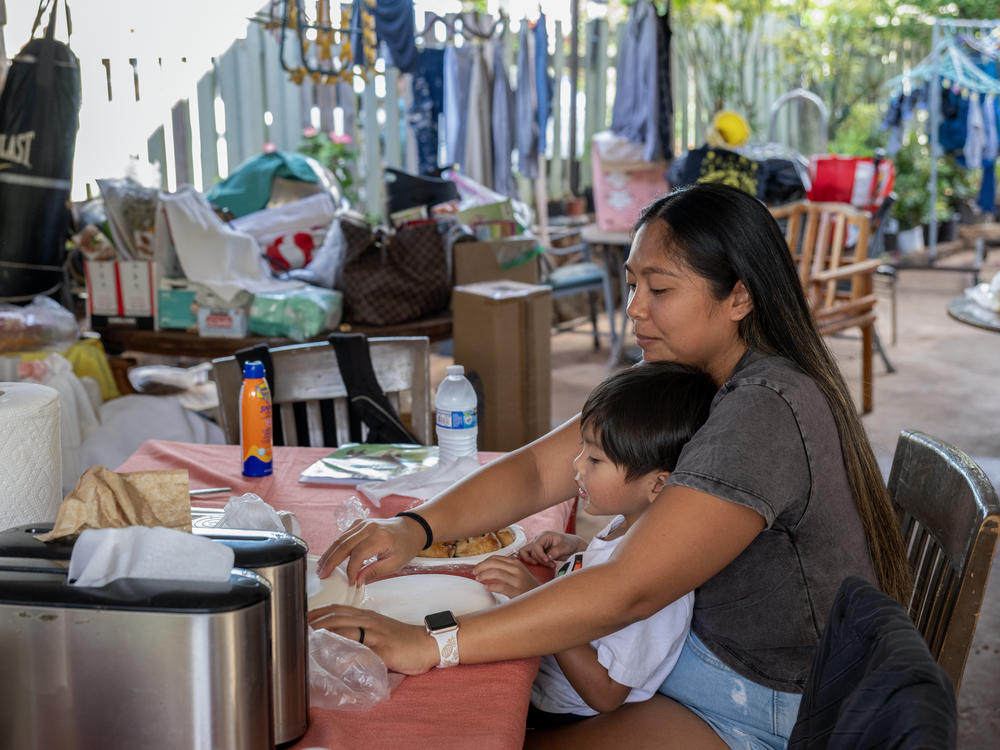 Daisy Andres Ballesteros, and her son Sebastian, 4, are at the multi-generational home in Lahaina where she lived with her parents, and her siblings' families. It's not livable after the wildfires.