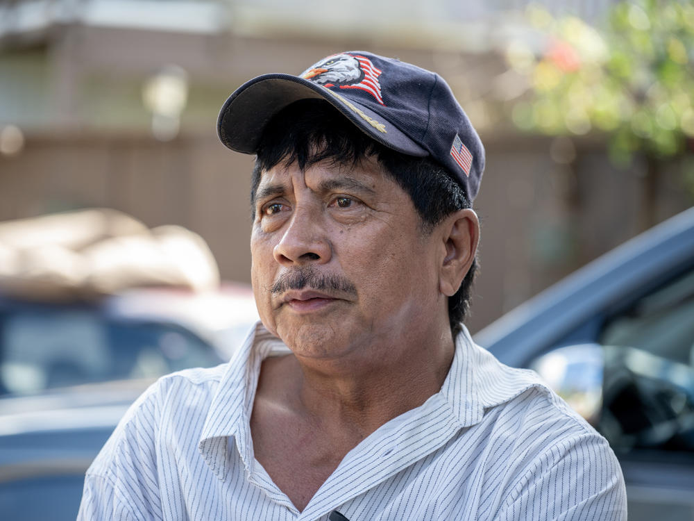 Danilo Andres has started the cleanup-up at his family home, preparing to haul away ash-soiled contents.