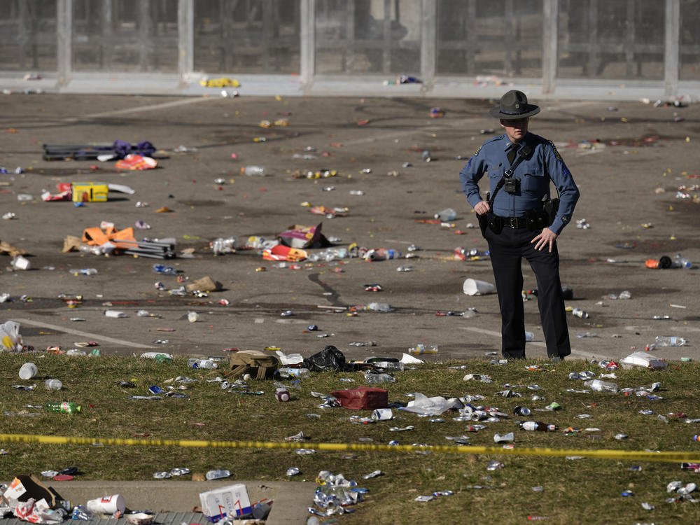 A law enforcement officer looks around the scene after the shooting following the Kansas City Chiefs' victory parade on Wednesday.