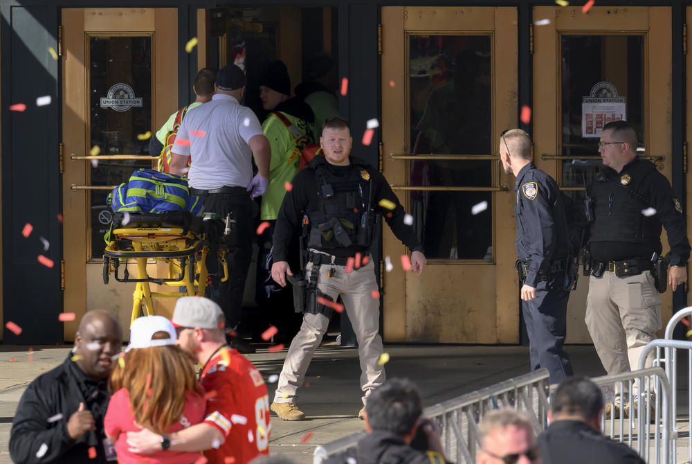 Emergency personnel (left) take a stretcher into Union Station.