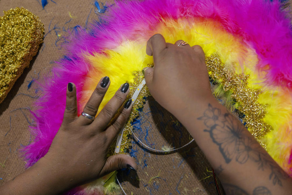 Members of the Bem Feito bate-bola crew work on the finishing touches for their costumes for this year's Carnival at the group's warehouse in Campo Grande, a neighborhood in Rio de Janeiro.