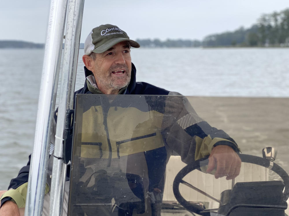 Chris Dollar steers his boat on the Ware River in Gloucester, Virginia in September. A charter fishing captain and conservation advocate, Dollar said he sees fewer fish in the bay and its tributaries than he used to. Schools of menhaden that used to be 