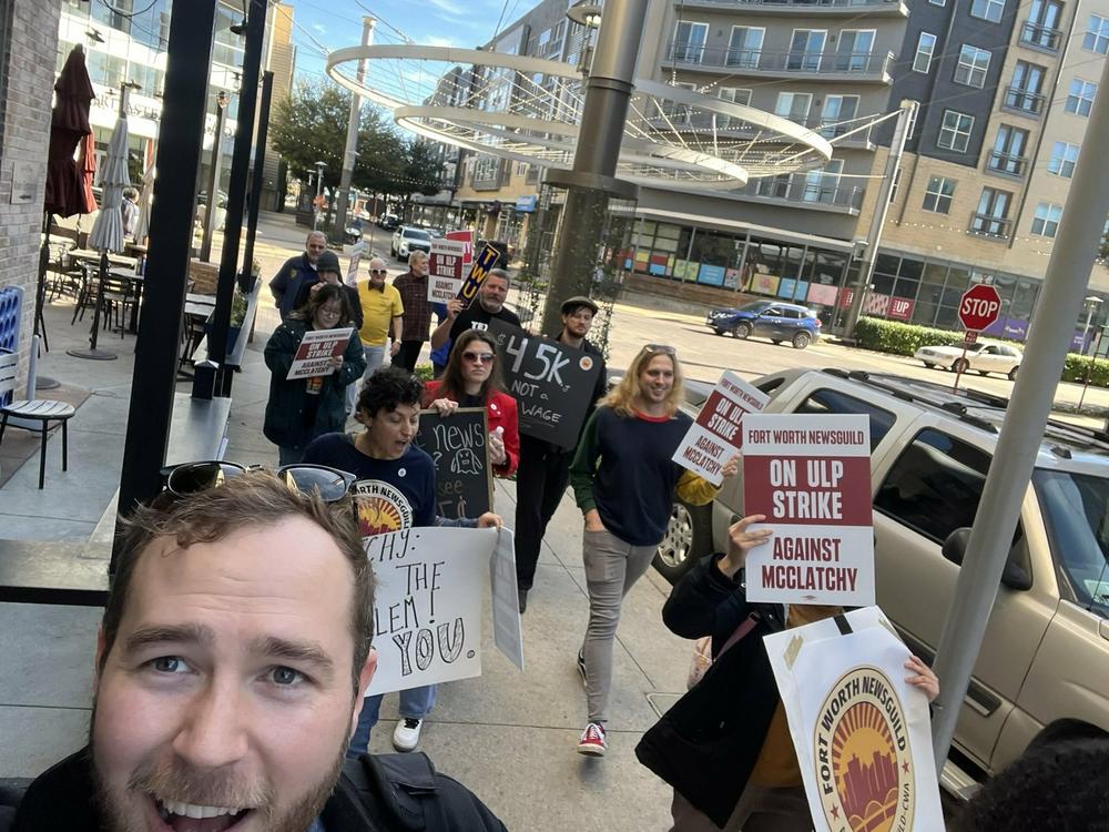 NewsGuild President Jon Schleuss (foreground) marches with journalists at the <em>Fort Worth Star-Telegram </em>during a strike in November 2022.