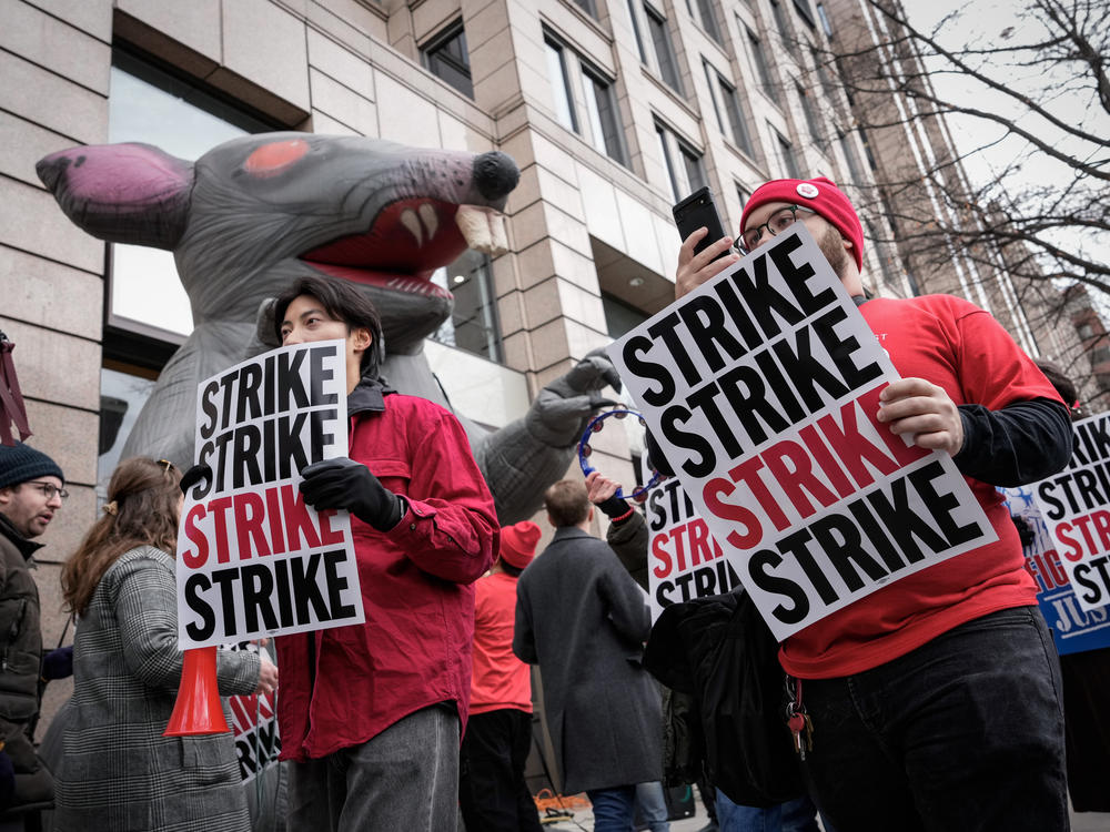 <em>Washington Post</em> staff picket during a 24-hour strike outside the newspaper's building in December 2023.