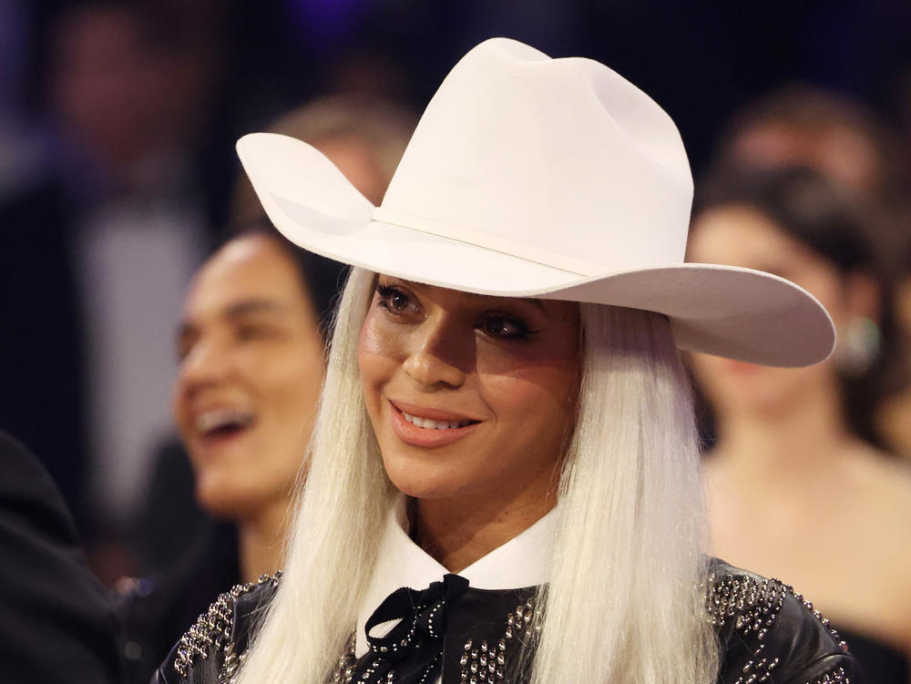 Beyoncé watches Jay-Z as he accepts the Dr. Dre Global Impact Award during the 66th Grammy Awards on Feb. 4.