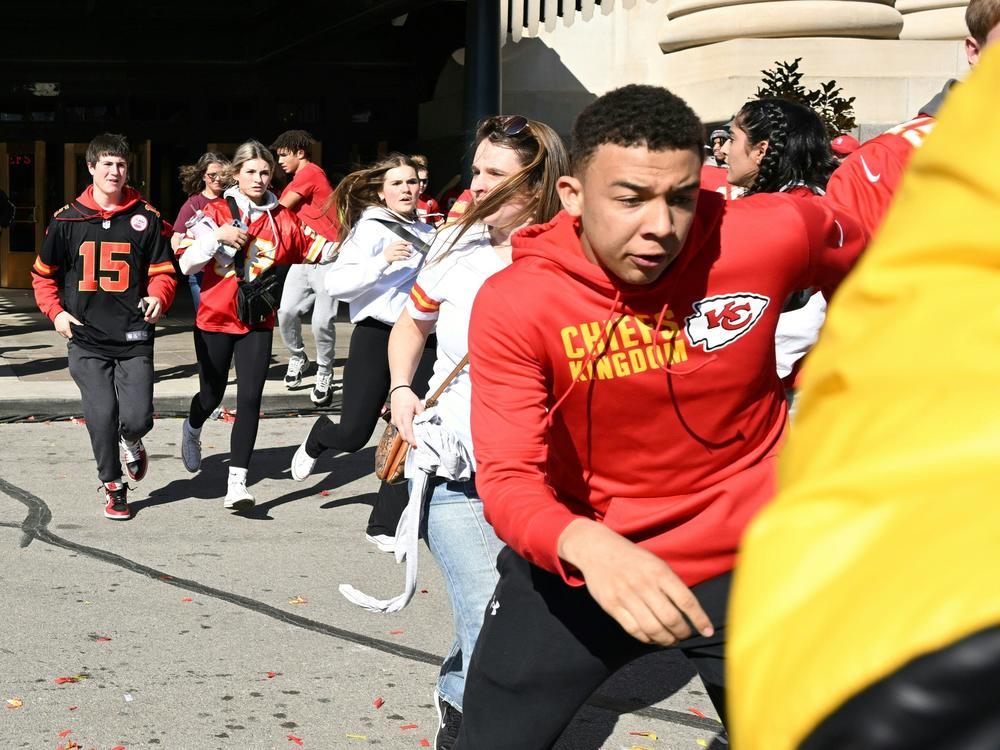 People flee after shots were fired near the Kansas City Chiefs' 2024 Super Bowl victory parade on Wednesday in Kansas City, Mo.