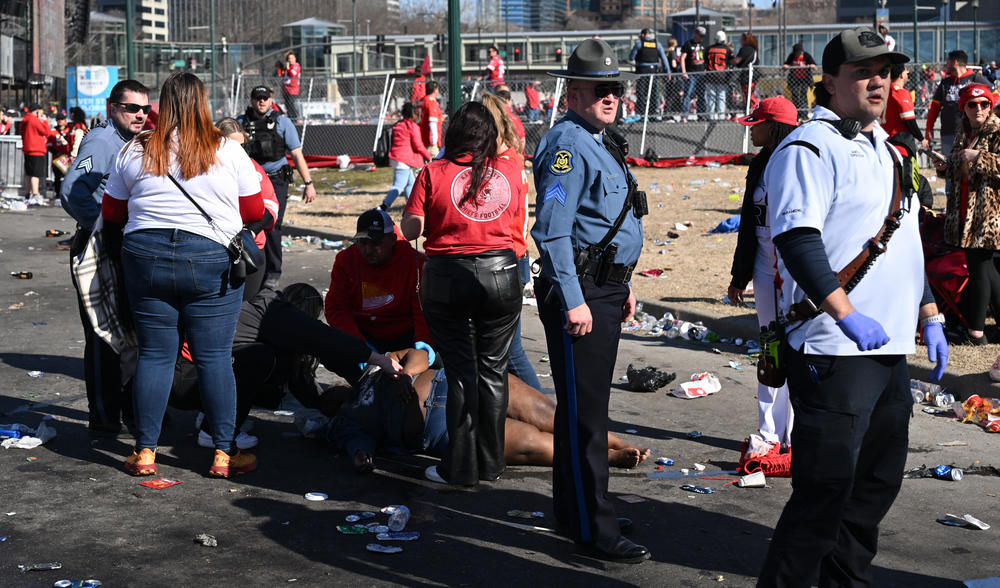 An injured person is helped near the Chiefs' victory parade.