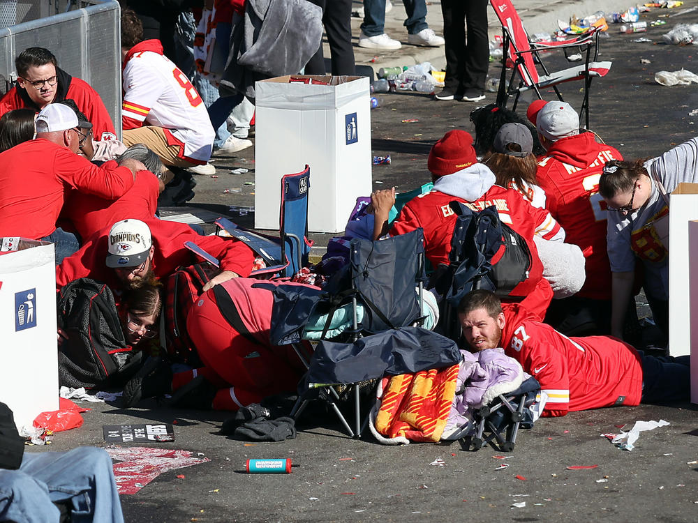 People take cover during the shooting at Union Station shortly following the Kansas City Chiefs' Super Bowl victory parade on Feb. 14 in Kansas City, Missouri.