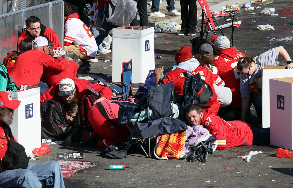 People take cover during a shooting at Union Station during the Kansas City Chiefs' victory celebration.