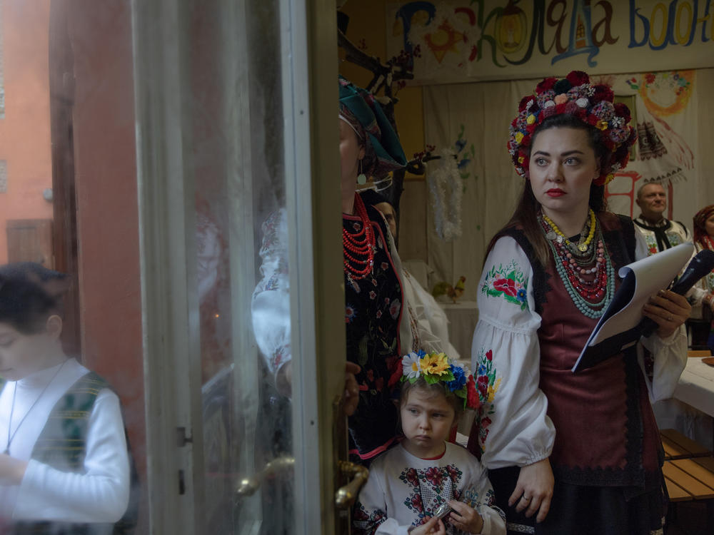 Ukrainian caregivers and their family gather to celebrate Ukrainian Christmas, although not on the precise day of the holiday, in Bologna, Italy, in January 2023. Continuing to celebrate holidays despite the grief of the war allows Ukrainians in Italy feel closer to their homeland.