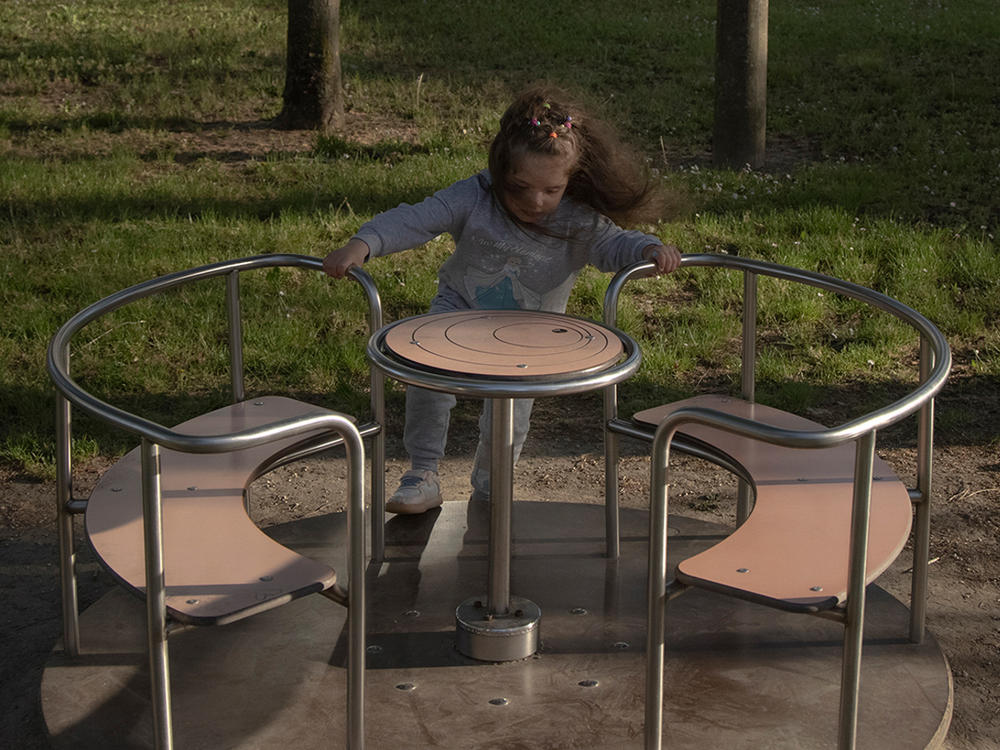 Milana Dorosh plays at the park in Rovigo, Italy, in April 2022. Milana, her mother and brother escaped to this town after war broke out in Ukraine.