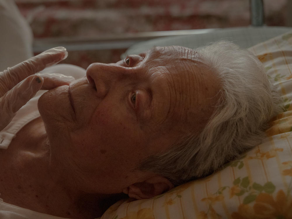 Lyubov's hand tenderly caresses Lidia's face. Lyubov, who has lived in Italy since 2007, started caring for Lidia in January 2021. Lyubov played a vital role in my grandmother's physical and psychological recovery. The two built a strong bond in a short time. Within a year, my grandmother was achieving small successes every day with Lyubov's help.