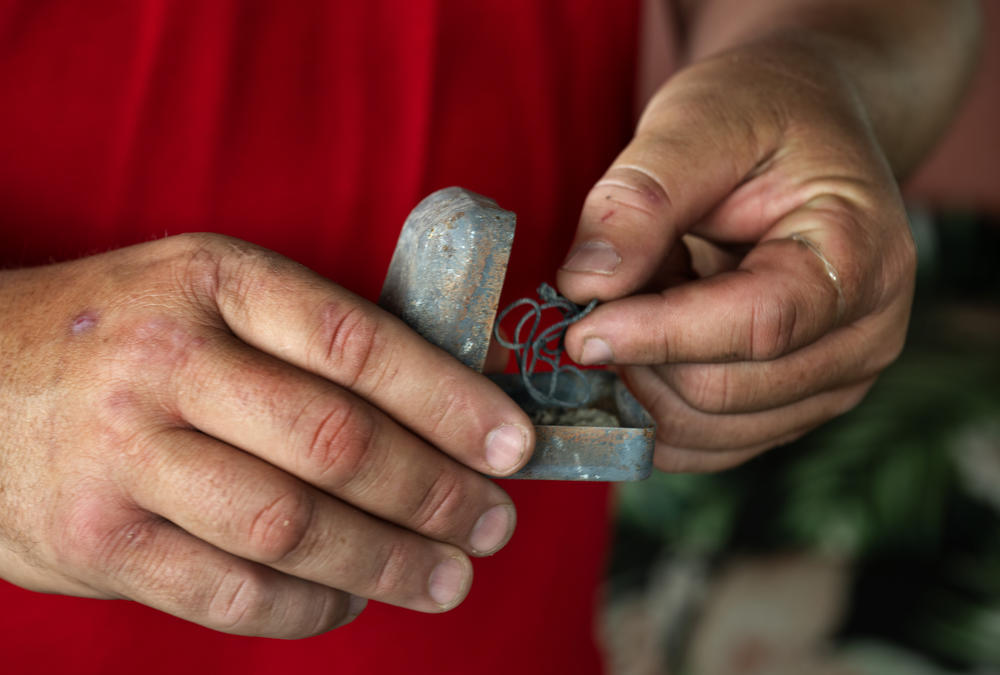 Matthew Souza searched for his wife's wedding rings in the rubble at their burn home after the fire, but found hardly anything intact. He holds a random jewelry box found on site.