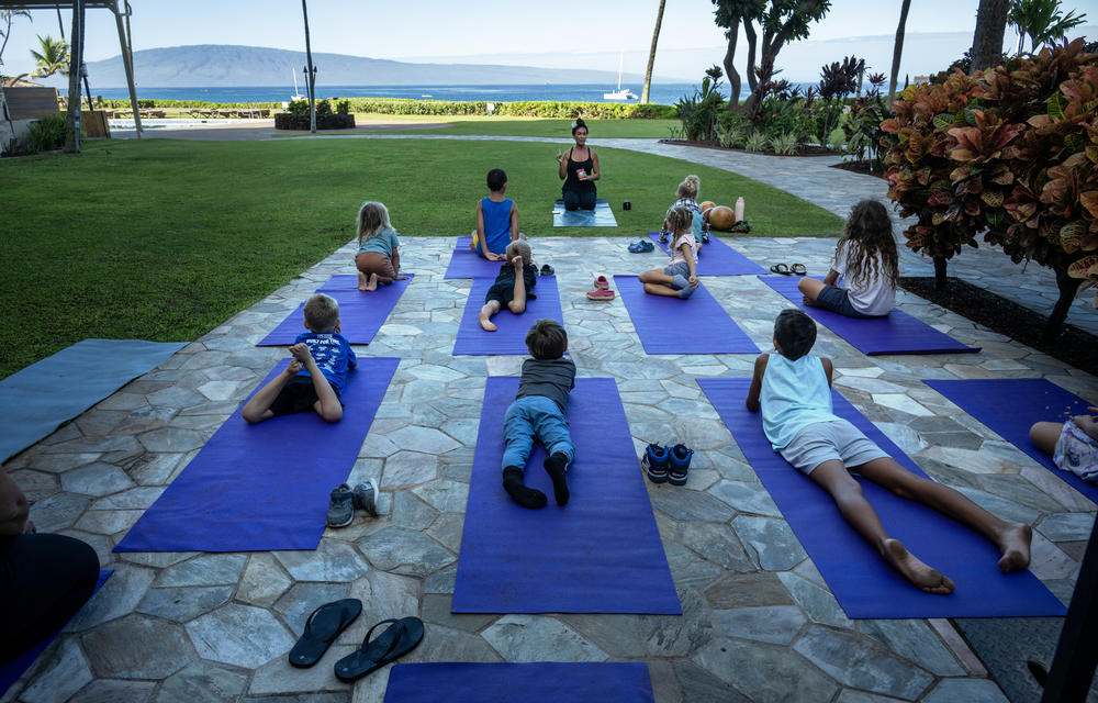 Kilihune Ka'aihue teaches a yoga class to children from Lahaina, many who lost their homes.