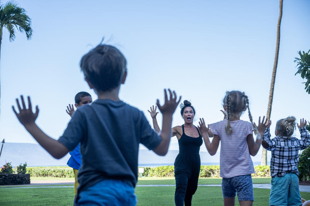 Kilihune Ka'aihue teaches a yoga class to children from Lahaina, many of whom lost their homes. Maui Arts and Cultural Center (MACC) Arts and Healing programming is held at the Royal Lahaina Resort where many displaced residents are temporarily staying.
