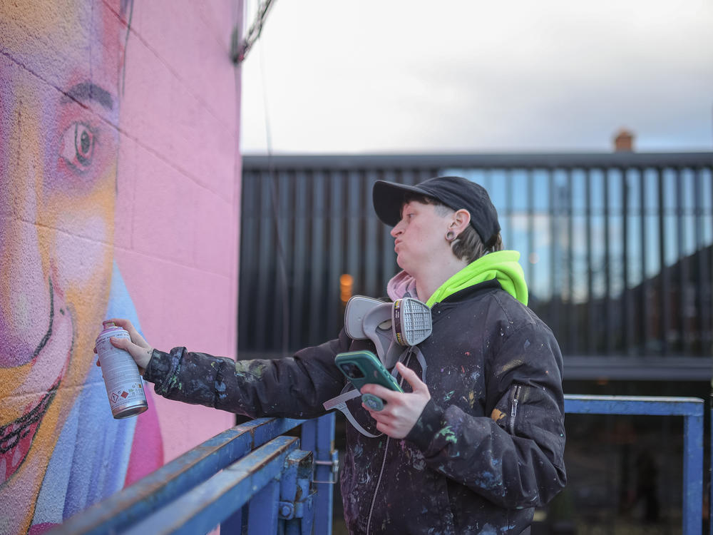 Emmalene Blake works on her second mural of Masa on Feb. 11 in Dublin.