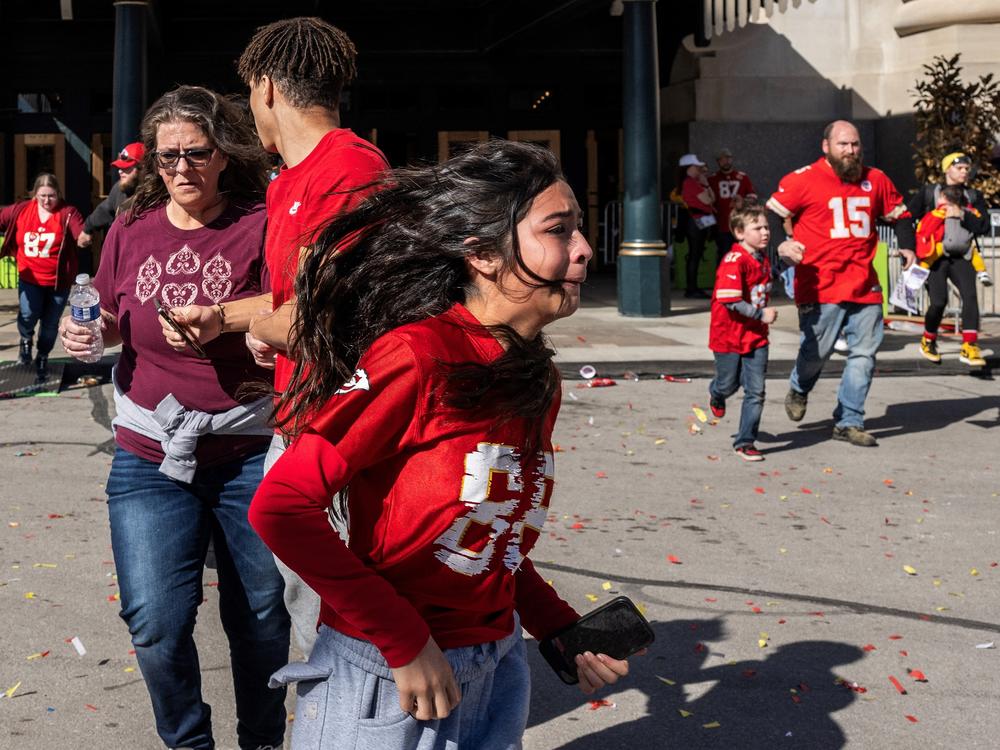 People flee after shots were fired near the Kansas City Chiefs' Super Bowl victory parade on Wednesday in Kansas City, Mo.