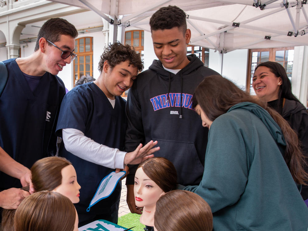 Mannequin heads offer a chance for men to practice hairstyling. Luis Rodríguez (second from left), a medical student, says the lesson made him appreciate his mom's workload at home. As for ponytails, he said he'd tried to do his sister's hair before, but this was the first time he felt confident about the result. 