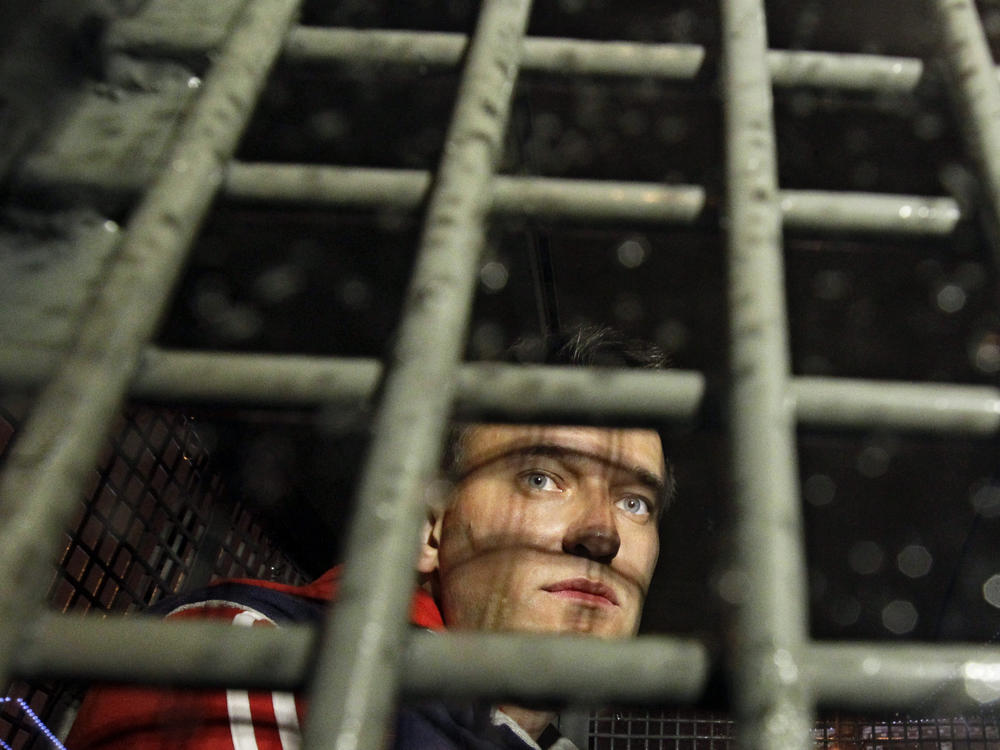 May 8, 2012: Alexei Navalny is seen behind the bars in the police van after he was detained during protests in Moscow, on a day after Putin's inauguration.