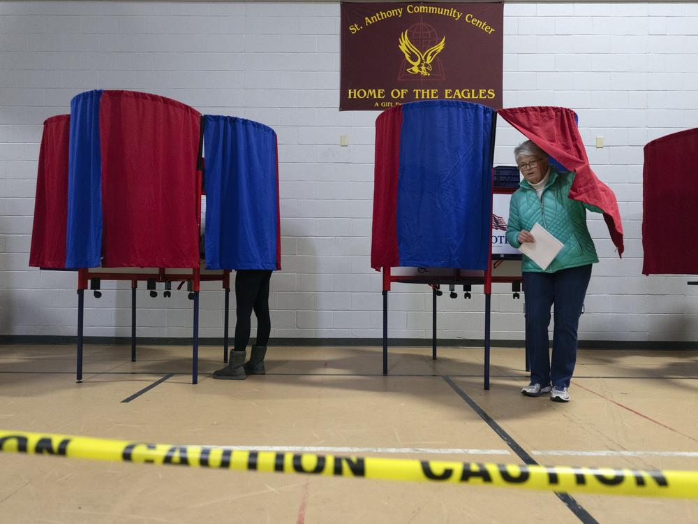 A voter leaves a polling booth at St. Anthony Community Center in Manchester, N.H., during the state's presidential primary on Jan. 23.