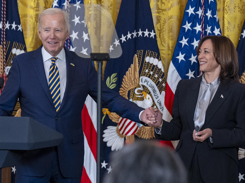 President Biden, holds hands with Vice President Kamala Harris as he speaks at a reception in recognition of Black History Month in the East Room of the White House in Washington, Tuesday, Feb. 6.