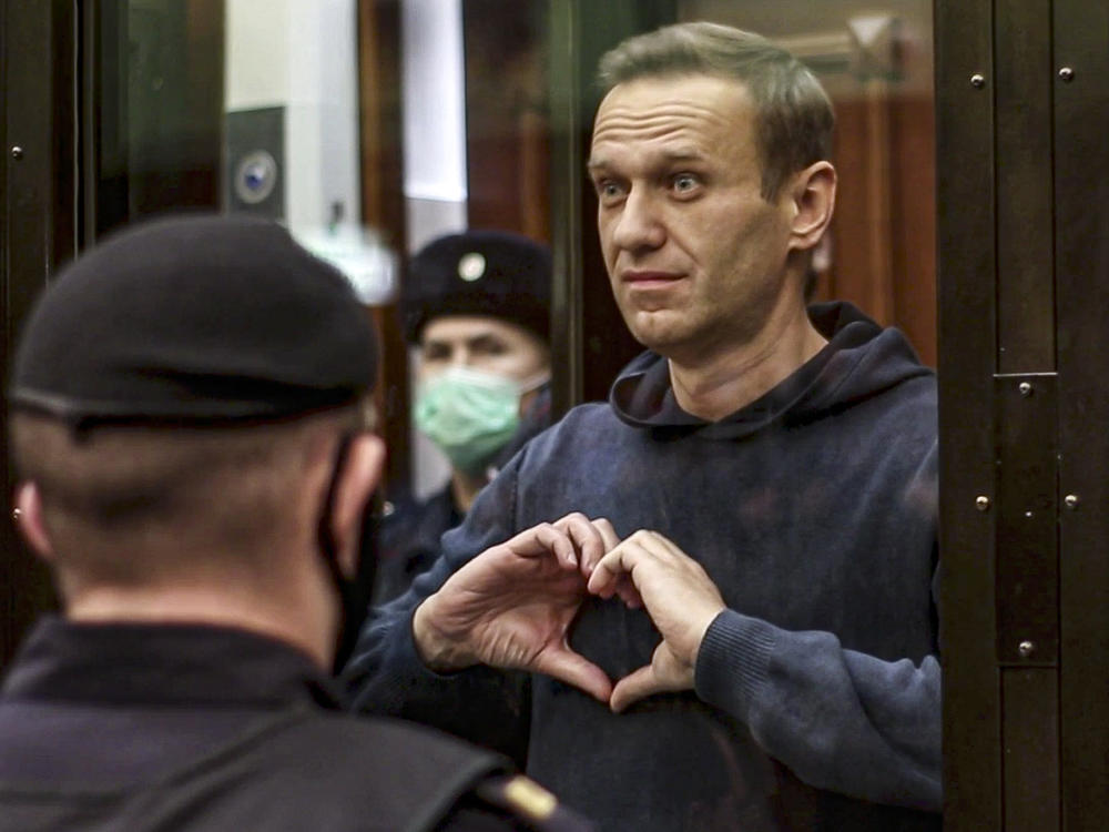 Feb. 21, 2021: Russian opposition leader Alexei Navalny shows a heart symbol standing in the cage during a hearing to a motion from the Russian prison service to convert the suspended sentence of Navalny from the 2014 criminal conviction into a real prison term in the Moscow City Court in Moscow, Russia.