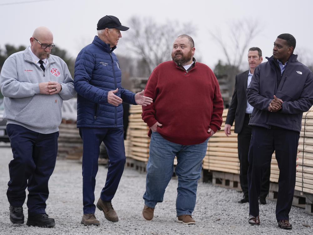 President Biden talks with East Palestine, Ohio Mayor Trent Conaway during a tour of the site where a train carrying toxic chemicals derailed a year ago.
