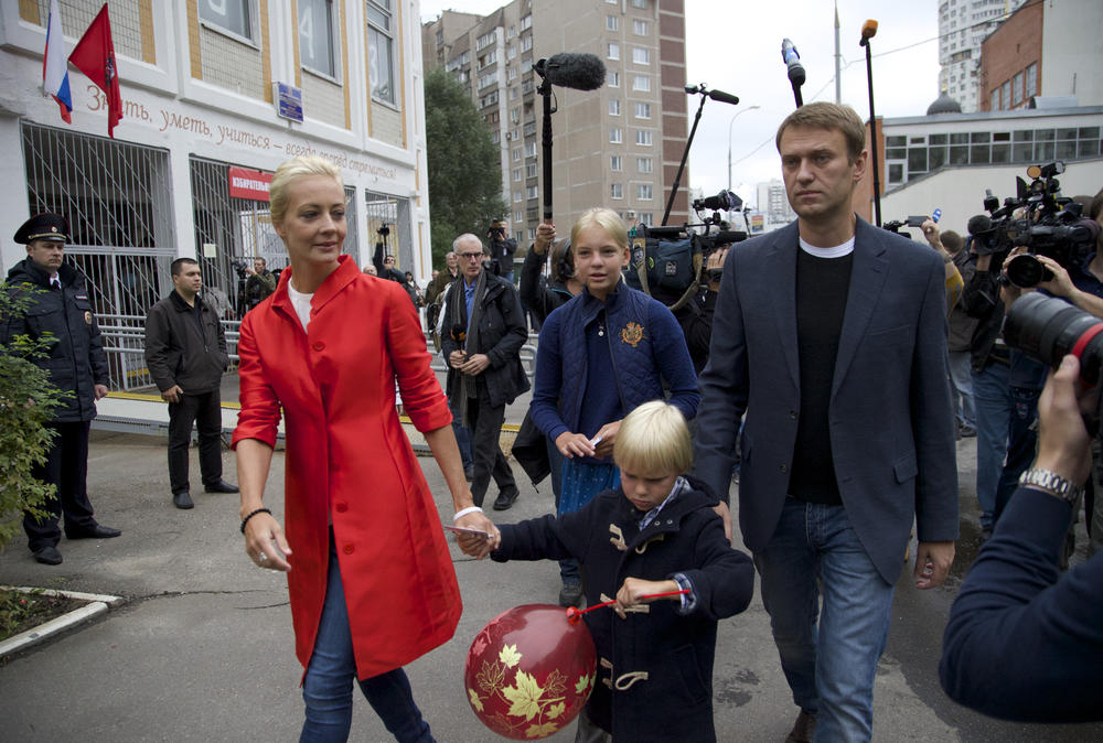 Sept. 8, 2013: Russian opposition leader Alexei Navalny, right, with his wife Yulia, daughter Daria, and son Zakhar leave a polling station in Moscow's mayoral election. Moscow is holding its first mayoral election in a decade.