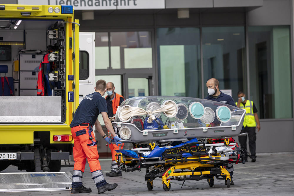 August 22, 2020: German army emergency personnel load portable isolation unit into their ambulance that was used to transport Russian opposition figure Alexei Navalny at Charite hospital on  in Berlin, Germany. Navalny has arrived in Germany at Charite Hospital in Berlin for treatment for possible poisoning.