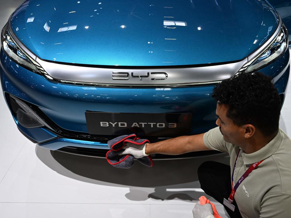 A man polishes an Atto 3 car from Chinese car maker BYD at the International Motor Show (IAA) in Munich, Germany, on Sept. 4, 2023. The car has gained in popularity among Europeans.