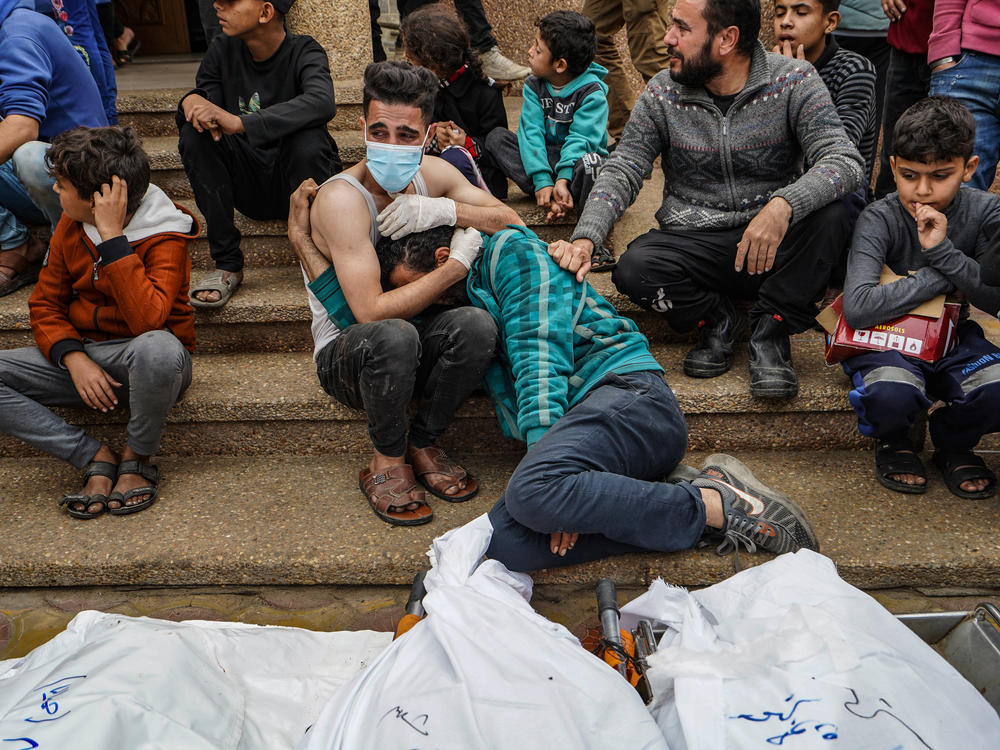 Palestinians mourn relatives killed in an Israeli strike at Nasser Hospital in Khan Younis, Gaza Strip, on Dec. 28, amid continuing battles between Israel and the Palestinian militant group Hamas.