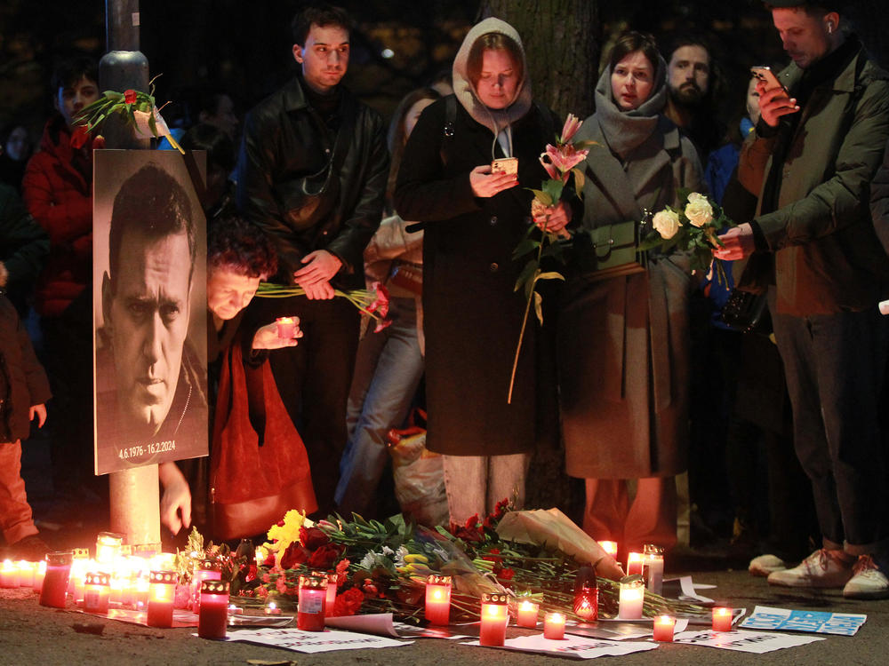 Protesters light candles on Friday in front of the Russian Embassy in Prague after the announcement that the Kremlin's most prominent critic, Alexei Navalny, had died in an Arctic prison.