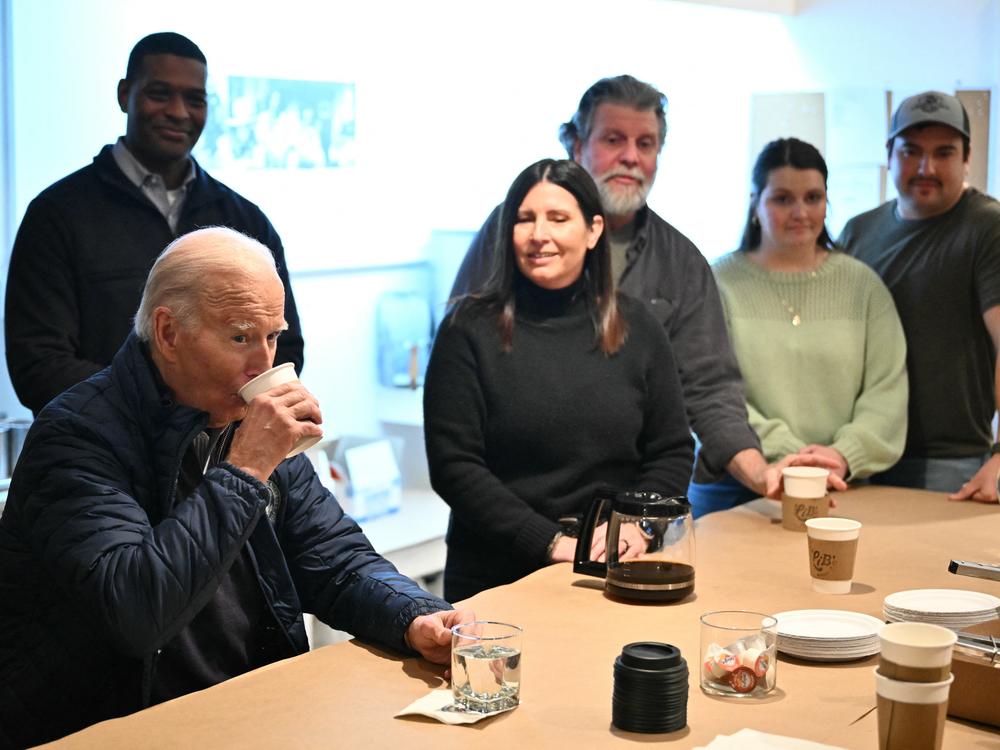 President Biden takes a sip of water during a stop at a candle shop in East Palestine, Ohio on Feb. 16, 2024.