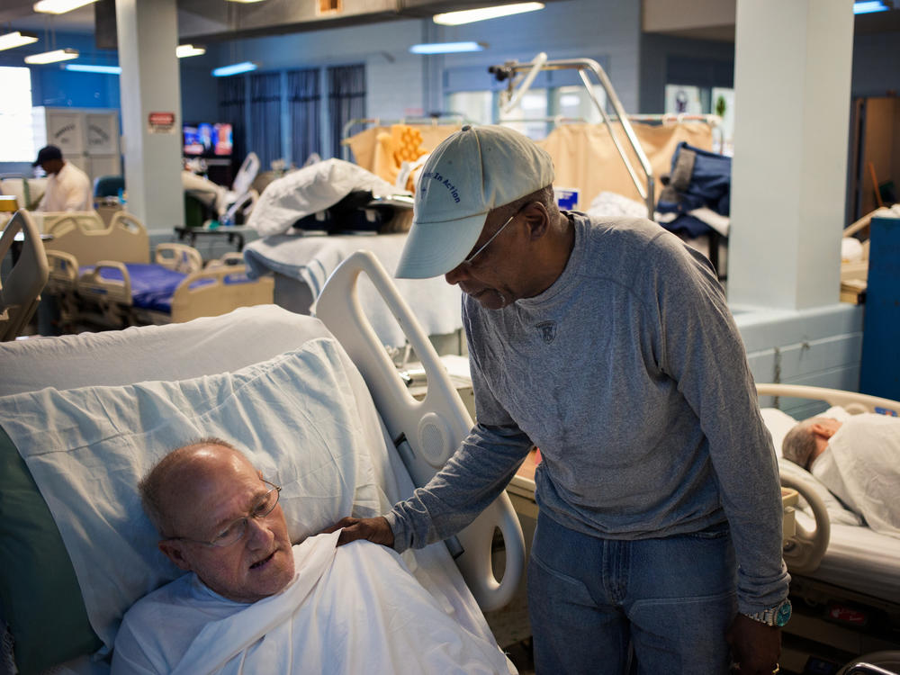 Donald Murray is one of the few selected inmates who take care of other aging inmates at Angola prison in Louisiana. Here he cares for Clyde Giddens.