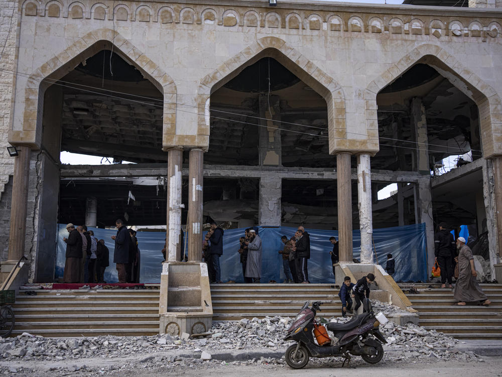 Palestinians pray in a damaged mosque following an Israeli strike in Rafah on Thursday, Feb. 15.