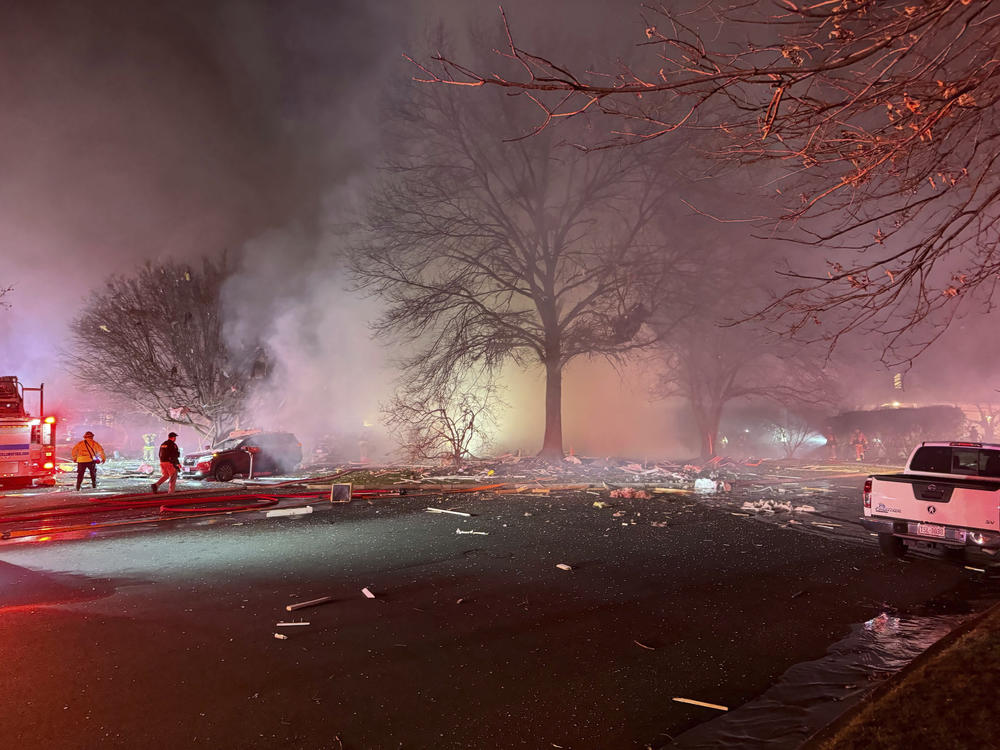 First responders arrive at the scene after an explosion at a house late Friday in Sterling, Va.
