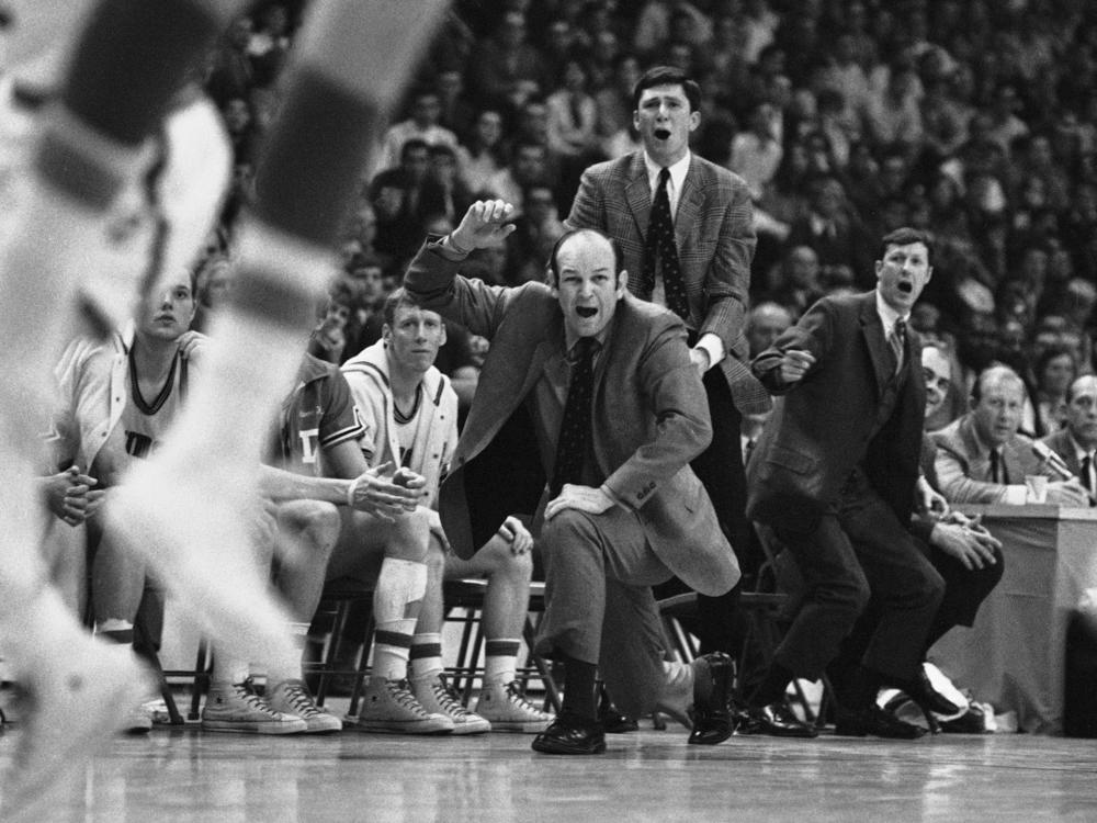 Davidson head coach Lefty Driesell drops to a knee in front of his bench as he watches North Carolina win an NCAA Eastern Regional basketball tournament at College Park, Md., on March 15, 1969. Driesell, the coach whose folksy drawl belied a fiery on-court demeanor that put Maryland on the college basketball map, died Saturday.