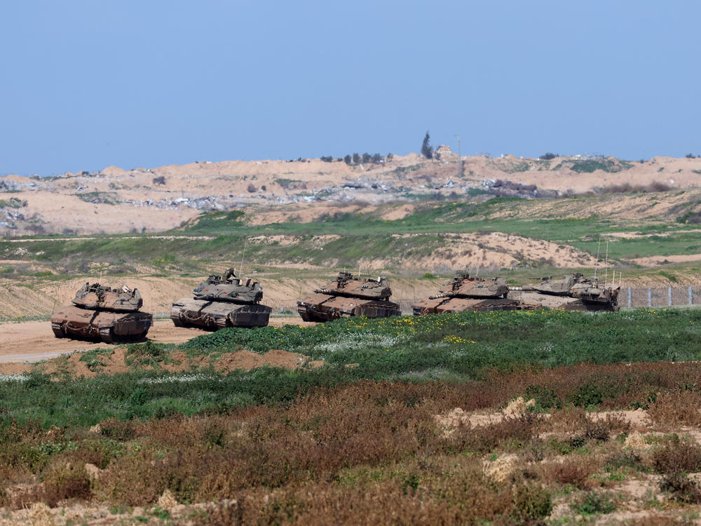 Israeli tanks are seen along the border with the Gaza Strip in southern Israel on Thursday, Feb. 15.