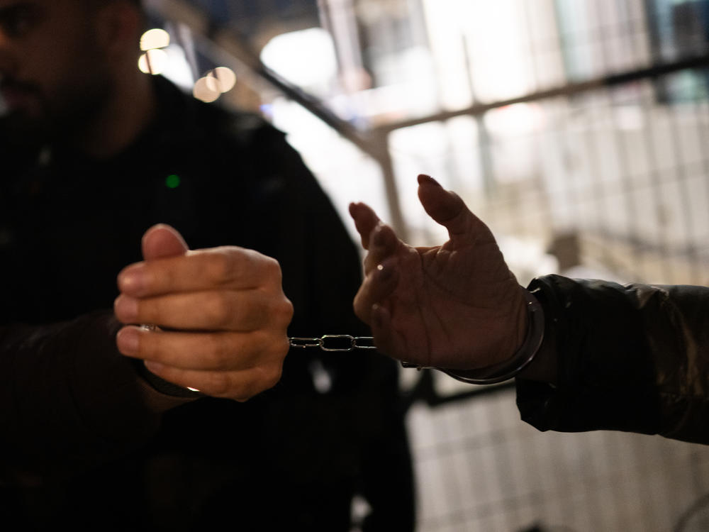 Family members of the hostages being held in Gaza handcuff themselves to one another on  Thursday, Feb. 15, outside The Kirya, in Tel Aviv, which houses the Israeli Ministry of Defense, during a protest calling for a deal to secure their relatives' release.