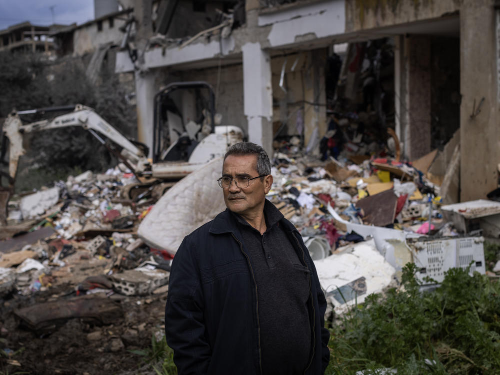 Mahmoud Kamil Barjawi poses for a portrait outside the home of his cousin, who fell victim to an Israeli attack on Thursday, Feb. 15, that claimed the lives of at least seven members of the same family and three Hezbollah fighters who were in the building, according to Lebanese local media.