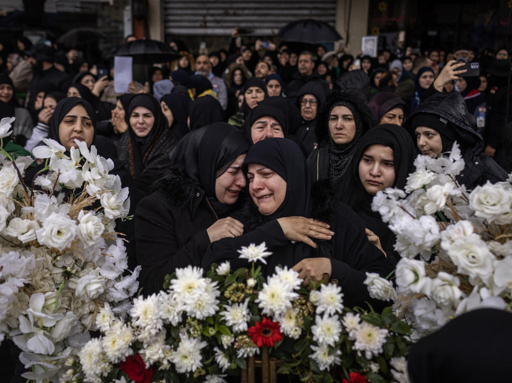 Residents of the southern Lebanese city of Nabatiyeh gather Saturday, Feb. 17, to mourn the seven members of the Berjawi family that were killed in their home by Israeli rockets on Thursday.