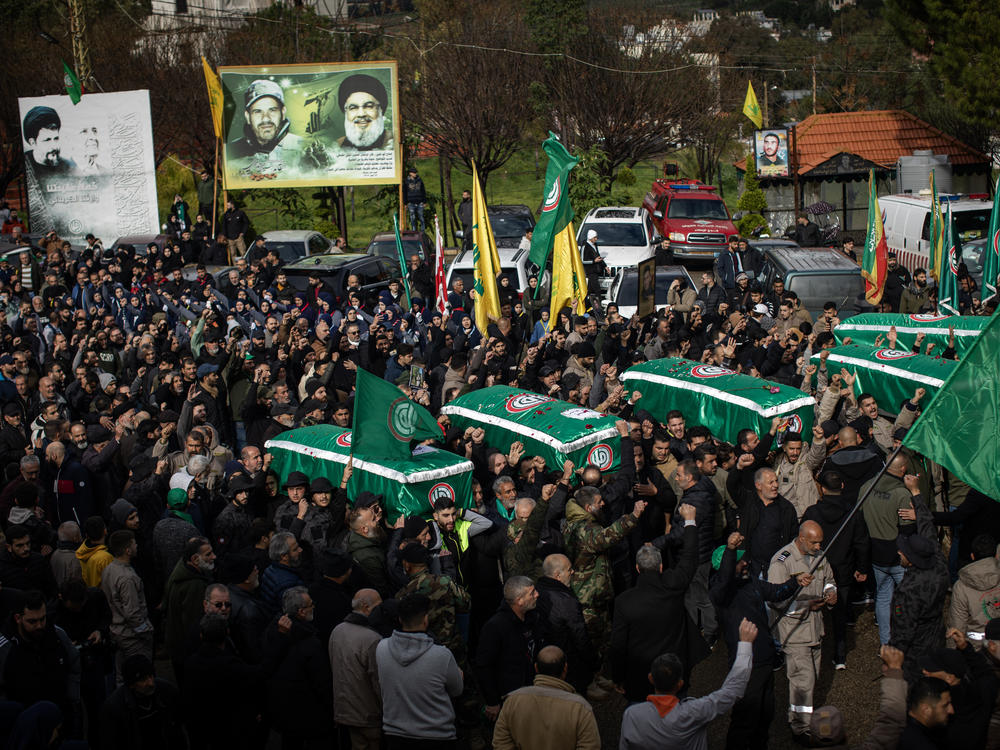 Residents of the southern Lebanese city of Nabatiyeh join relatives Saturday, Feb. 17, in mourning the loss of seven members of the Berjawi family, who were killed in their home by Israeli rockets on Thursday, Feb. 15.
