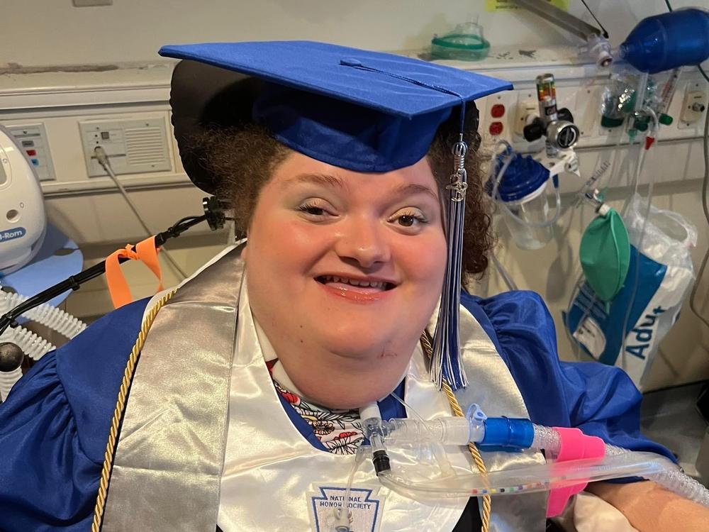 Alexis Ratcliff, in cap and gown for the invitations she sent for her high school graduation. It took a judge's order to tell the hospital to help her leave the hospital and attend her graduation ceremony.