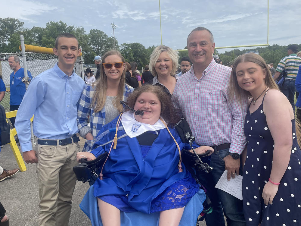 The Ratcliff family, including Alexis' sister Apple (right), celebrates with Alexis at her high school graduation.