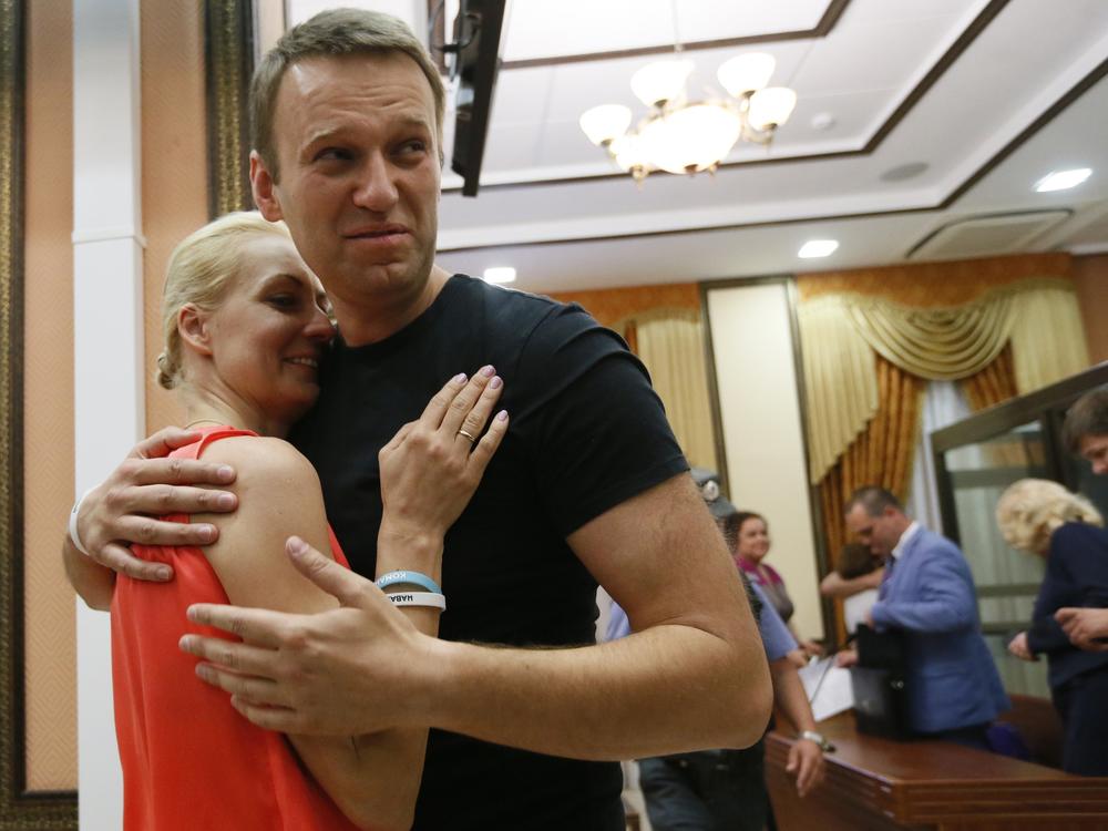 Russian opposition leader Alexei Navalny, right, embraces his wife Yulia, as he was released in a courtroom in Kirov, Russia, on July 19, 2013. Navalny died in prison on Friday.